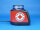 Mobile Warnanlage mit blauer Kennleuchte und roter Beklebung, darauf ist das Logo des Deutschen Roten Kreuzes abgebildet, seitliche Ansicht